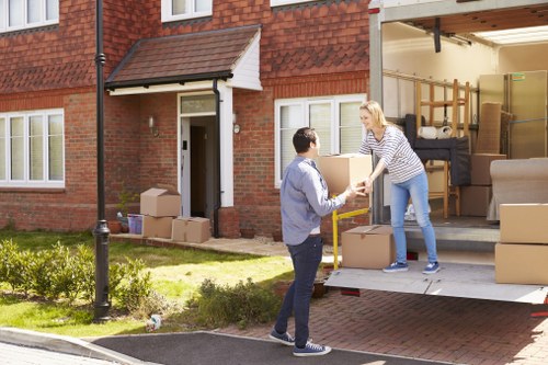 Student removals moving boxes in a Canary Wharf apartment building