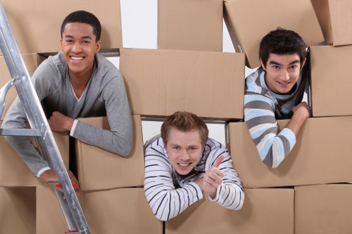 Team lifting furniture carefully to prevent injury